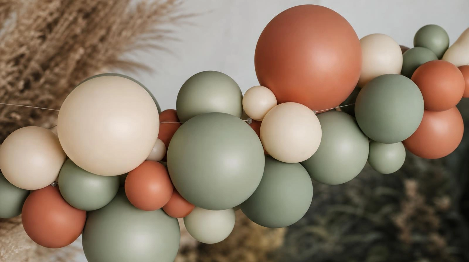 Close-up of a no-kit balloon garland cluster tied onto fishing line